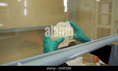 Work in the laboratory. Clip. The job of a chemist who pours liquid and checks it Stock Photo