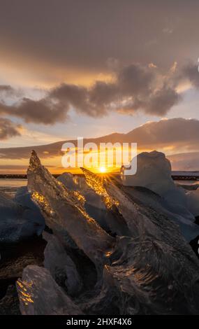 sun shining through ice at Diamond Beach, Breidamerkursandur, southeast Iceland Stock Photo