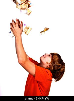 Euros flying around a boys head Stock Photo