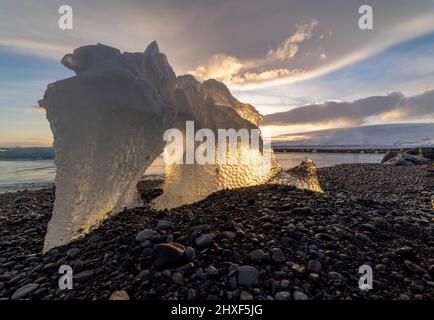 sun shining through ice at Diamond Beach, Breidamerkursandur, southeast Iceland Stock Photo