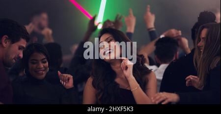 Dancing her way into 2020. Cropped shot of an attractive young woman dancing in a nightclub. Stock Photo