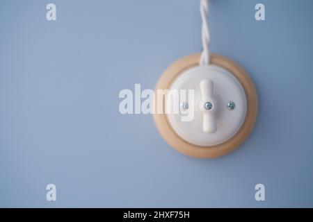 Retro light switch solated on blue background. Stock Photo