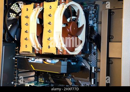The modern desktop computer inside. Processor with big fans and video card on the motherboard. Stock Photo