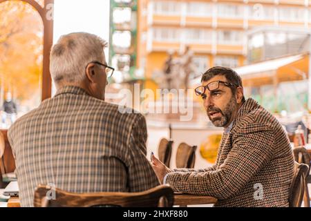 Two senior businessmen are having a serious conversation Stock Photo