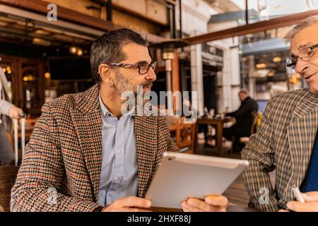 Two senior businessmen are having a conversation and smiling Stock Photo