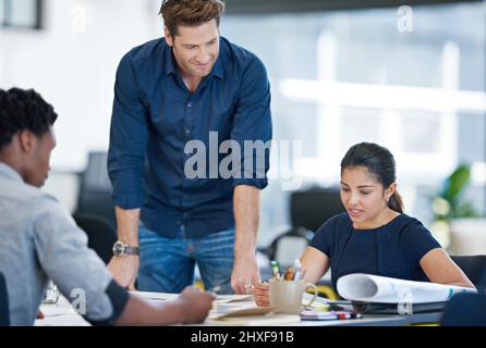 Modern business pros. Shot of a group of young designers working together in an office. Stock Photo