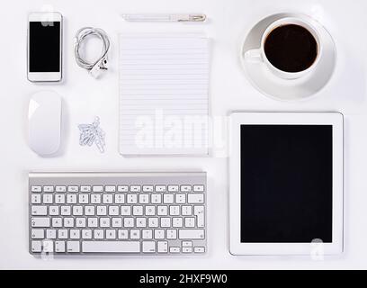 Instruments of productivity. A high angle view of various office equipment items and digital devices. Stock Photo