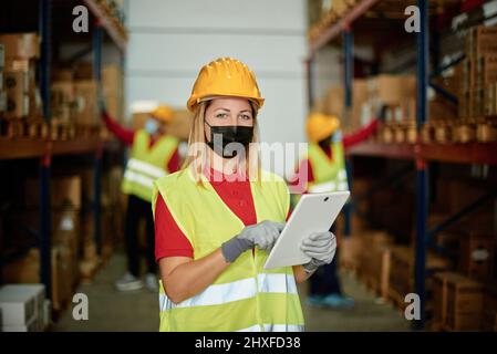 Man in mask using tablet Stock Photo