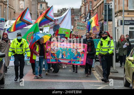 Glasgow, Scotland, UK. 12th March, 2022. Campaigners join the Women's March For Equality from Govanhill Park to Queens Park as part of International Women's Day celebrations. Credit: Skully/Alamy Live News Stock Photo