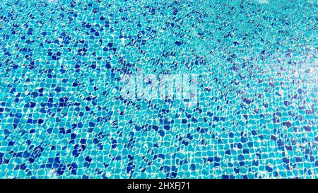 Swimming pool surface top view caustics ripple and flow with waves background, Swimming pool for background. Texture of water surface. Stock Photo