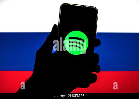 In this photo illustration a Spotify logo seen displayed on a smartphone with a flag of Russia in the background. (Photo by Thiago Prudencio / SOPA Images/Sipa USA) Stock Photo