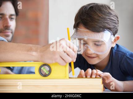 Carpentry is a family profession. A father and son doing woodwork together. Stock Photo