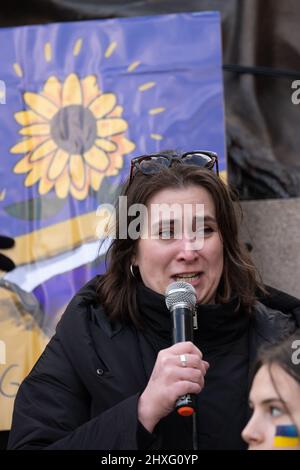 Manchester, UK. 12th Mar 2022. Woman who intoduces herself as 'Anastacia' and Russian offers a tearful apology for her countries actions in Ukraine as protesters gather in Manchester city centre, UK, to protest about the war in Ukraine. Protestors are calling for a stop to the war and the introduction of a no fly Zone by NATO. Picture garyroberts/worldwidefeatures.com Credit: GaryRobertsphotography/Alamy Live News Stock Photo