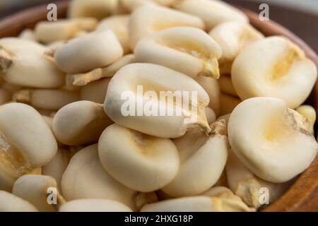 Whole dried hominy. Dry maize mote grain in wooden bowl. Macro Stock Photo