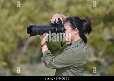 Men holding Nikon Z9 mirror less camera. A young man doing a photo shoot. Stock Photo