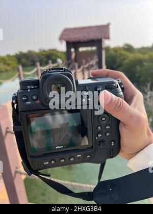 Men holding Nikon Z9 mirror less camera. A young man doing a photo shoot. Stock Photo