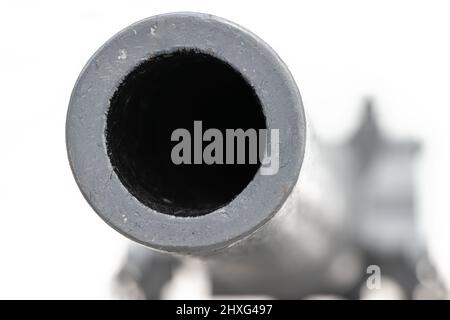 The barrel of the cannon aims front into a camera, on a white background Stock Photo