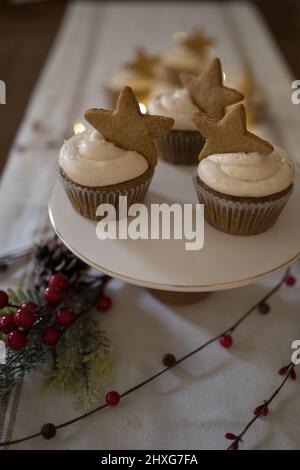 cupcakes on cake stand, wood table, and white tablecloth Stock Photo
