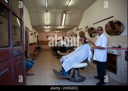 Customer clientele and barber's in a barber shop in Havana, Cuba. Stock Photo