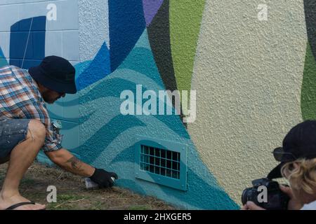 Tauranga New Zealand - December 11 2015; Street artists at work painting large scale patterned street art on city building wall Stock Photo