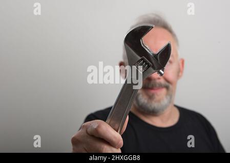 middle age worker with wrench in his hand Stock Photo