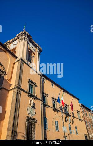 Feb.6, 2022 - Tarquinia, Viterbo, Lazio, Italy - The main square of the village. The town hall illuminated by the sun, in the blue sky. Tower with the Stock Photo