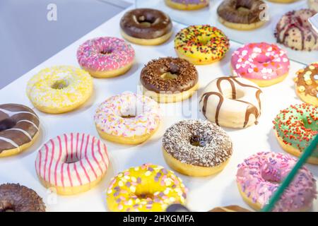 Different donuts are on display in a pastry shop Stock Photo