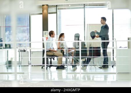 Lets hear everyones opinion. Shot of a group of colleagues brainstorming in an office. Stock Photo