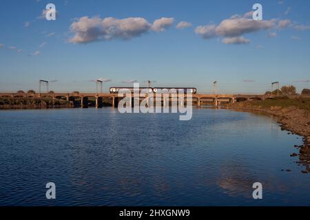 Scotrail class 156 sprinter train crossing the river Esk railway viaduct at Mossband on the  west coast mainline Stock Photo