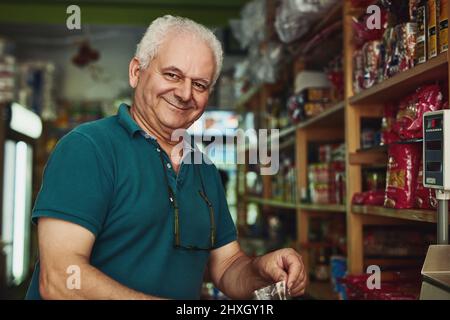 Its never too late to do what you really want. Shot of a senior man working in a store. Stock Photo