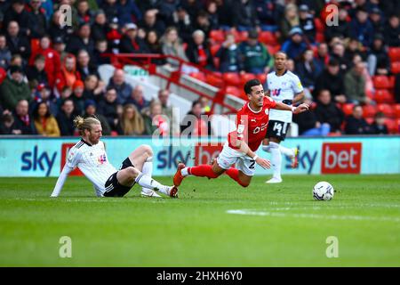 Oakwell, Barnsley, England - 12th March 2022 Amine Bassi (27) of Barnsley is fouled by Tim Ream (13) of Fulham - during the game Barnsley v Fulham, Sky Bet EFL Championship 2021/22, at Oakwell, Barnsley, England - 12th March 2022 Credit: Arthur Haigh/WhiteRosePhotos/Alamy Live News Stock Photo