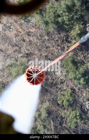 Water is dropped from a bambi bucket attached to a CH-47 Chinook helicopter on wildfires near Daegu. Stock Photo