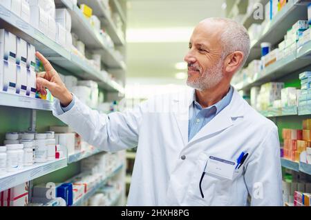 Pharmaceutical expertise you can rely on. Shot of a mature pharmacist doing inventory in a pharmacy. Stock Photo