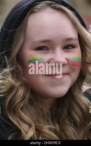 Peterborough, UK. 12th Mar, 2022. A child with a Lithuanian flag painted on her cheek arrives at the prayer ceremony. At a time when Ukraine is under attack from Vladimir Putin's Russia Lithuanians celebrate their restoration Independence Day at Peterborough Cathedral. They stand in support of Ukraine and hold the Ukrainian flags and ribbons. Lithuania regained their freedom from the Soviet Union on March 11th 1990. A short prayer and a minute's silence were held for the fallen defenders of freedom. (Photo by Martin Pope/SOPA Images/Sipa USA) Credit: Sipa USA/Alamy Live News Stock Photo