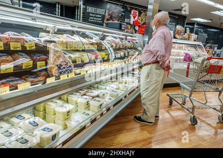 Miami Florida Winn-Dixie grocery store supermarket inside interior senior pensioner male man deli counter shopper shopping