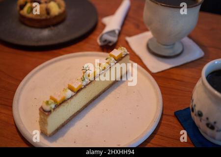 Lemon cheese bar on the plate with brown background. Stock Photo