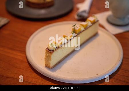 Lemon cheese bar on the plate with brown background. Stock Photo