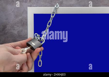 computer is locked. blocking social networks and software. monitor screen is covered with a chain. sanctions and restrictions.  Stock Photo