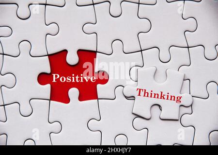 Positive thinking text on missing jigsaw puzzle. Motivational concept Stock Photo