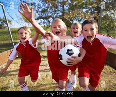 The field holds promise. Shot of a childrens soccer team. Stock Photo