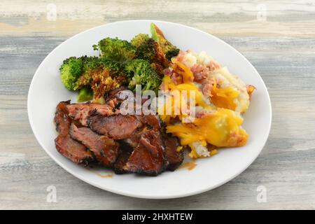 BBQ beef brisket with broccoli and mashed potatoes with cheese and bacon Stock Photo