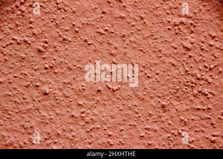 Close-up of pink painted concrete wall showing coarse sandy grains Stock Photo