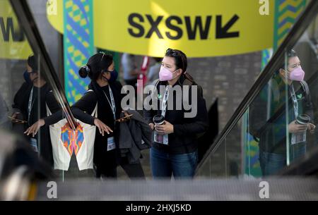 Texas, Texas, USA. 12th Mar, 2022. People ride an escalator at the South by Southwest (SXSW) Conference and Festivals in Austin, Texas, the United States on March 12, 2022. South by Southwest (SXSW) Conference and Festivals, a conglomerate of film screenings, interactive media, music festivals and conferences, opened Friday in Austin, making the capital city of U.S. state of Texas an ocean of cross-industry discoveries and innovations. Credit: Nick Wagner/Xinhua/Alamy Live News Stock Photo