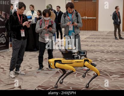 Texas, Texas, USA. 12th Mar, 2022. Visitors use their mobile phones to capture a Spot robot as it walks around at the Innovation Awards Finalist Showcase, during the South by Southwest (SXSW) Conference and Festivals in Austin, Texas, the United States on March 12, 2022. South by Southwest (SXSW) Conference and Festivals, a conglomerate of film screenings, interactive media, music festivals and conferences, opened Friday in Austin, making the capital city of U.S. state of Texas an ocean of cross-industry discoveries and innovations. Credit: Nick Wagner/Xinhua/Alamy Live News Stock Photo