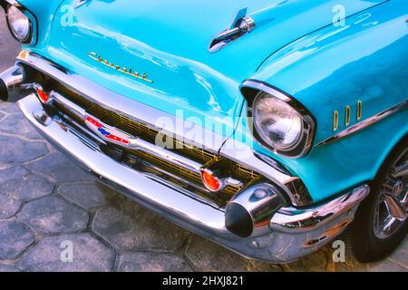 Closeup of the front of an aqua marine blue 1957 Chevrolet 150 with bullet bumper guards Stock Photo