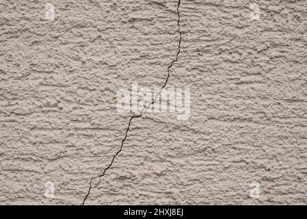 a crack in a white plastered wall Stock Photo