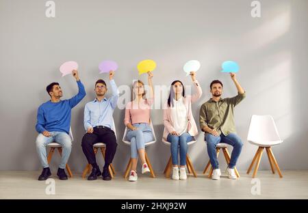 Group of young people thinking, holding speech bubbles and sharing their opinions Stock Photo