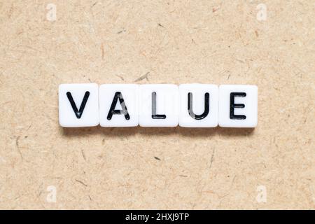 White tile alphabet letter with word value on wood background Stock Photo
