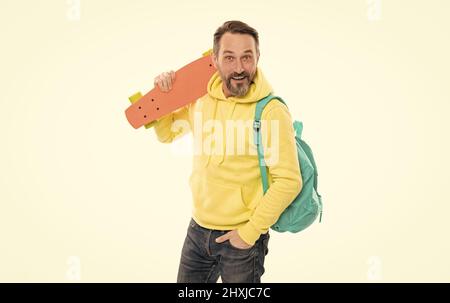 surprised man in yellow hoody with skateboard. adult skateboarder. male casual hipster style Stock Photo