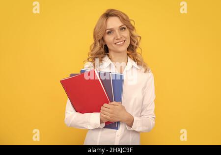 happy blonde businesswoman woman in white shirt hold notepad or notebook, teacher Stock Photo